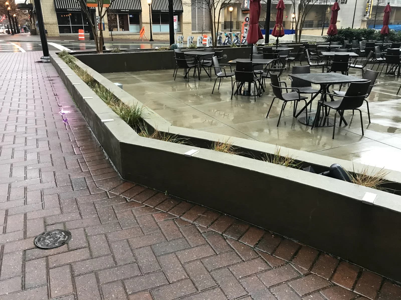 Granite ledge with stainless skate stoppers protecting a commercial office tower entrance